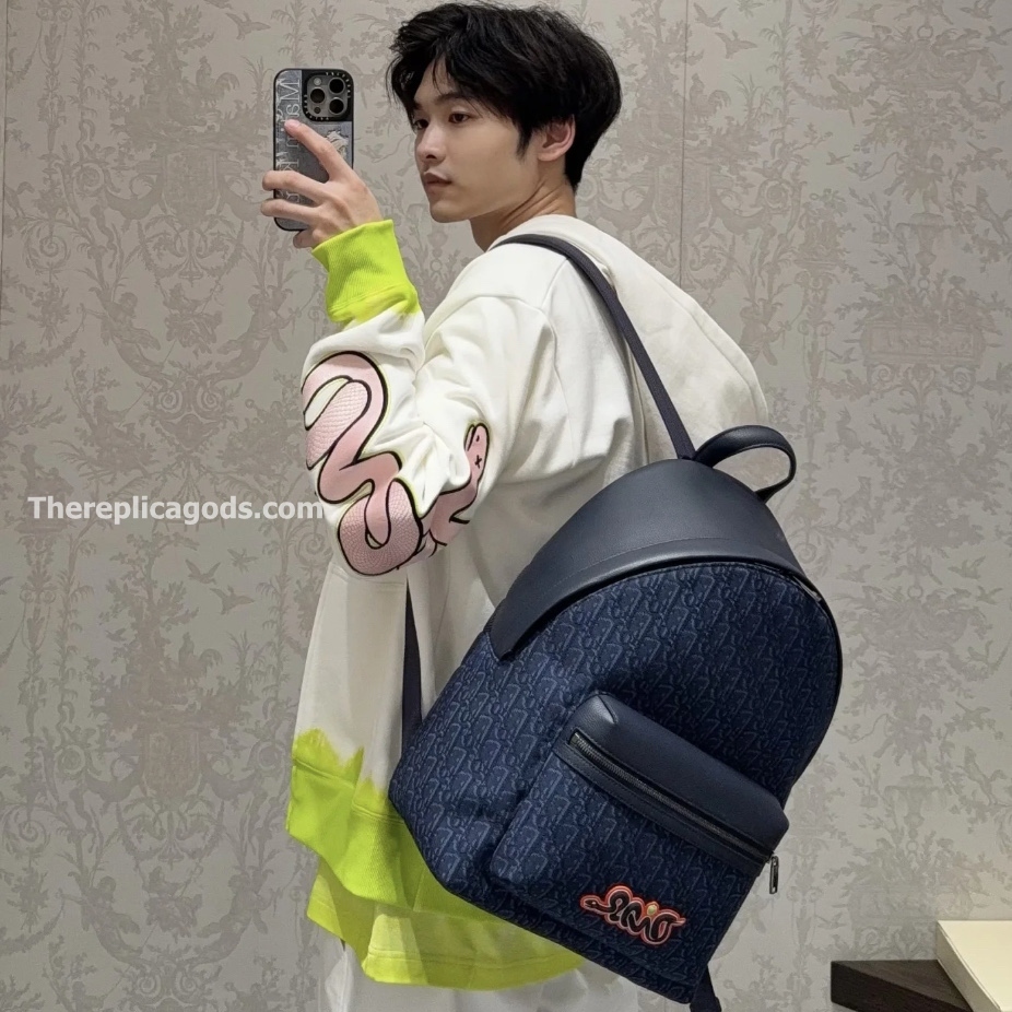 AND KAWS RIDER 2.0 ZIPPED BACKPACK NAVY BLUE GRAINED CALFSKIN AND OBLIQUE JACQUARD