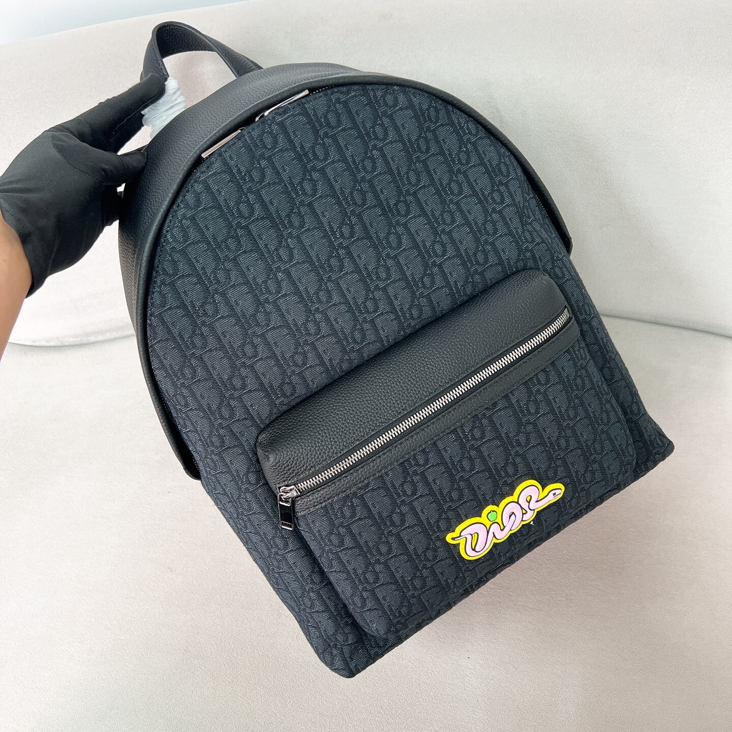 AND KAWS RIDER 2.0 ZIPPED BACKPACK BLACK GRAINED CALFSKIN AND OBLIQUE JACQUARD