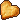 Pixel art heart shaped cookie that has a chunk out of it.