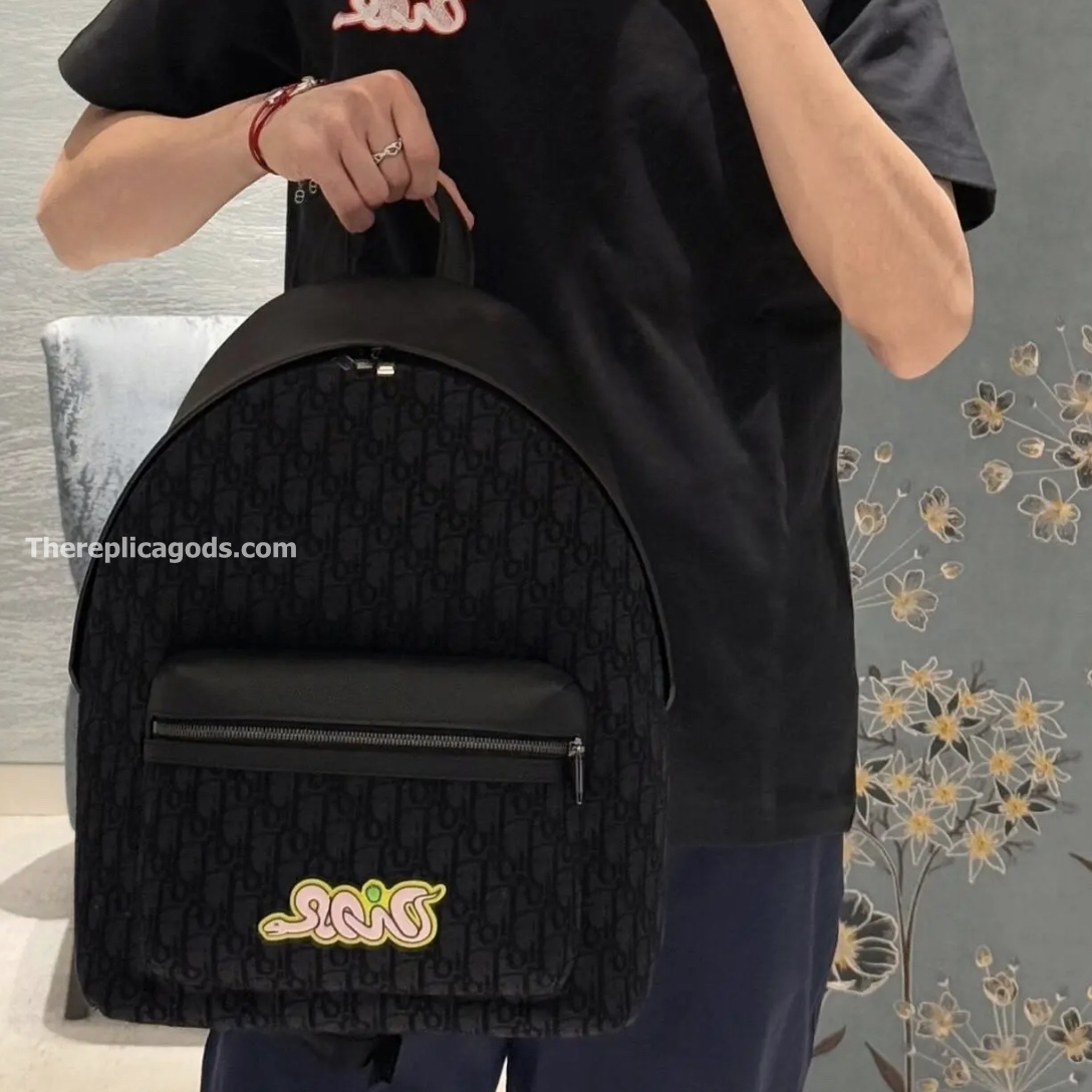 AND KAWS RIDER 2.0 ZIPPED BACKPACK BLACK GRAINED CALFSKIN AND OBLIQUE JACQUARD