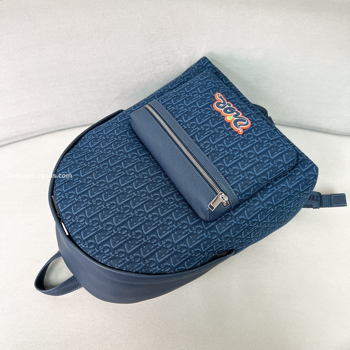 AND KAWS RIDER 2.0 ZIPPED BACKPACK NAVY BLUE GRAINED CALFSKIN AND OBLIQUE JACQUARD