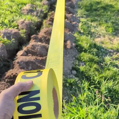 Image For Post | After partially filling in the trench, I laid caution tape in case anyone starts digging here in the future. I had some generic yellow tape laying around, but there is a [special tape for this purpose.](https://amzn.to/3nRqBEm)