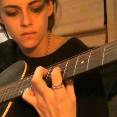 Image For Post | [Kristen holds your gaze for a moment then returns her attention to the instrument, her fingers delicately dancing over the frets as she concentrates. This feels hella awkward to you. You shake yourself off and try to raise some conversation again.]


You: "So how come a big superstar like you is hiding out in an old record store like this?" 


Kristen: "Who said I was hiding? Maybe no-one knows I'm here. Or maybe I'm not who you think I am." 


You: "No need to be so fretful." 


[You both laugh and the truly atrocious pun.]


Kristen: "Yup. You don't half meet some odd people when you're alone in a record store. But what's a girl to do. It's either this or the book signing. And I don't think I'm ready to face a frenzy of fans just yet." 


You: "So you most definitely are who I think you are then Kristen." 


[At the mention of her name, Kristen looks up again and into your eyes. You notice how beautiful she is up close and you feel like her eyes are staring into your soul.]