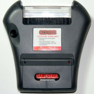 Image For Post | [Game Gear Game Genie]

The Game Gear version of the Game Genie had a more complicated design than those for other systems. When inserted into the cartridge slot, another slot would pop-up to insert the Game Gear cartridge. It also had a compartment which contained a book of codes. The codes were printed on sticky labels to put on the back of the Game Gear cartridge. When entering codes, the player could easily see what to type in rather than looking through the book.

On the screen in which a code is entered for the Game Gear Game Genie, a player typing the word "DEAD" will cause the screen to move up and down, possibly as an Easter egg.