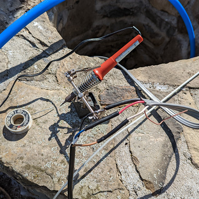 Image For Post | I soldered the connection of the well pump wire to the feeder wire, then insulated and sealed the connections with heat shrink tubing. This is a tidy way of doing it, but the wire nuts and the waterproof tape included with the pump also work.