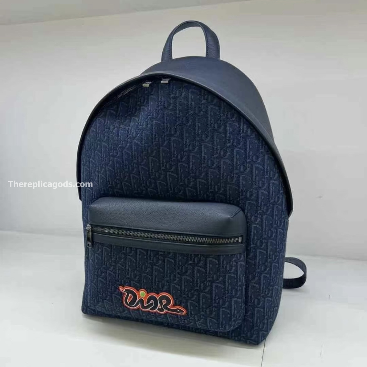 AND KAWS RIDER 2.0 ZIPPED BACKPACK NAVY BLUE GRAINED CALFSKIN AND OBLIQUE JACQUARD